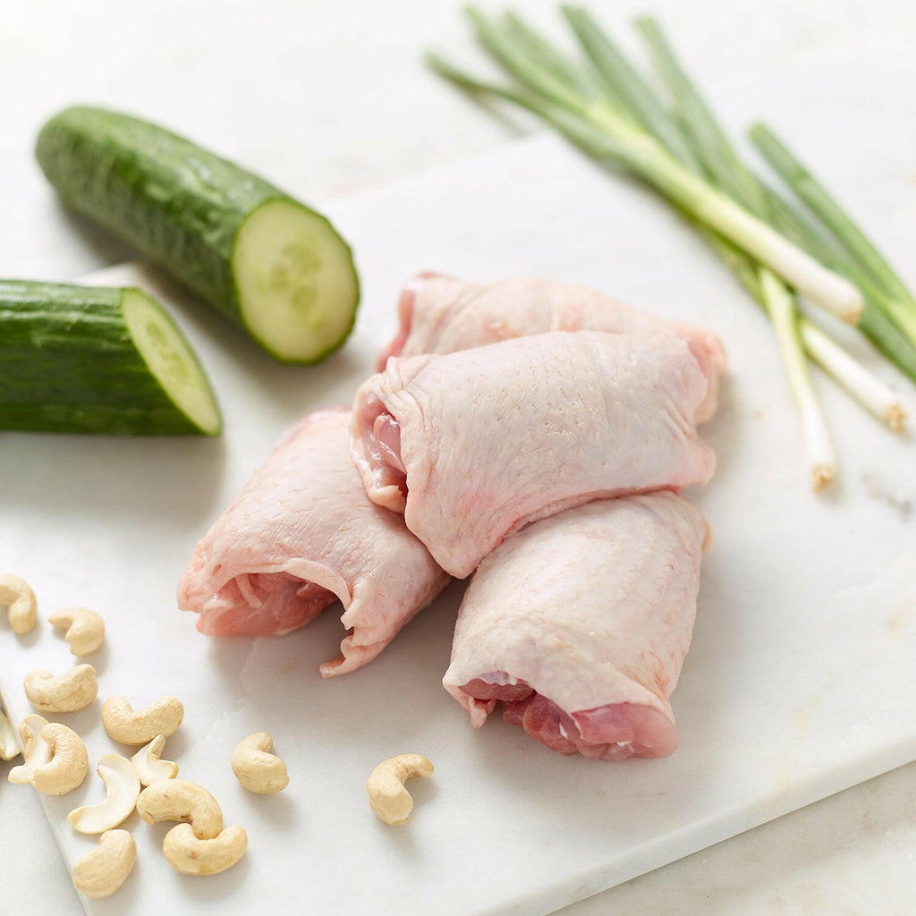 Organic Boneless Chicken Thighs with spring onions, cucumber halves and cashew nuts