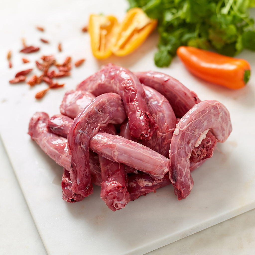 Organic Chicken Necks with birds eye chillies, whole and sliced peppers and coriander