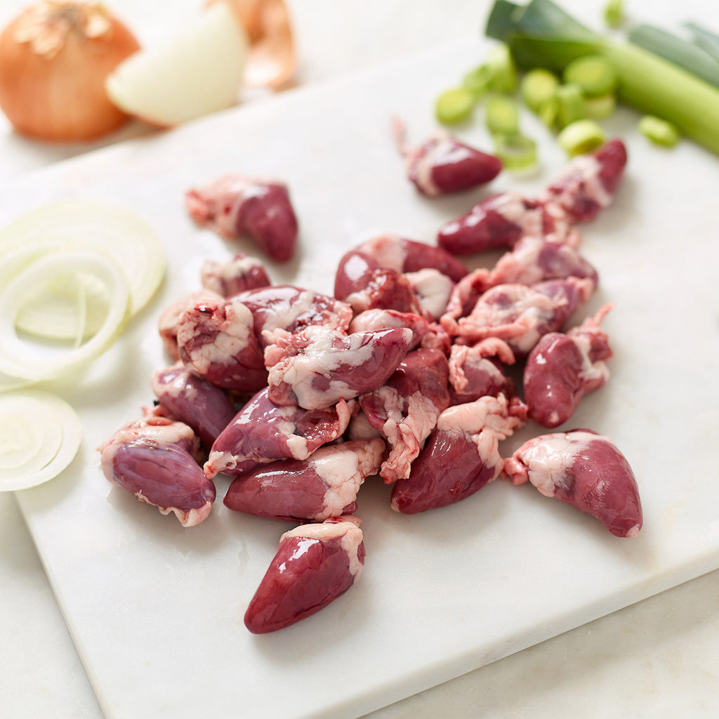 Organic Chicken Hearts with sliced white onion, whole white onions, sliced leek and whole leeks